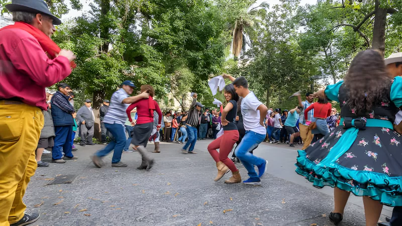 Cueca taking over the street. Music loud, feet quicker than memory, and strangers turning into dance partners in seconds.
