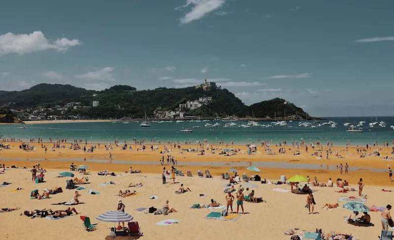 In Spain, life spills outdoors. Meals stretch, conversations echo, and even the beaches feel like extensions of the neighborhood, full of laughter, companionship, and ease that makes every day feel like summer.