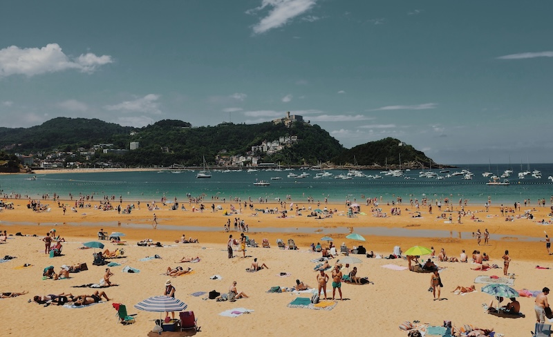 In Spain, life spills outdoors. Meals stretch, conversations echo, and even the beaches feel like extensions of the neighborhood, full of laughter, companionship, and ease that makes every day feel like summer.