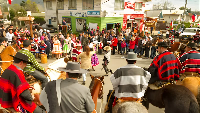 Circle of horsemen, dancers in the center. Cueca takes the spotlight and the whole town leans in to watch the story unfold.