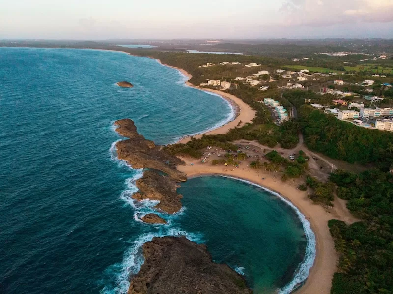 The north coast of Puerto Rico unfolds in layers of turquoise water, golden sand, and rugged rock, one of the many landscapes proving that the island holds the Caribbean dream in compact form.