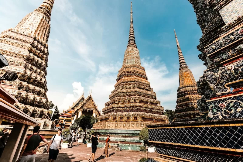 Temple spires rise beside shopping streets in Thailand, and the O-A retirement visa lets newcomers enjoy that blend once age and income requirements are met each year.