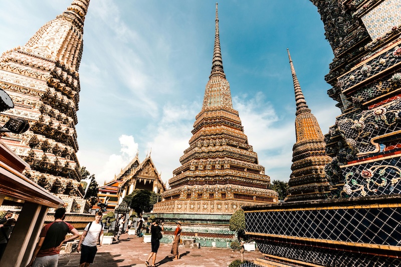 Temple spires rise beside shopping streets in Thailand, and the O-A retirement visa lets newcomers enjoy that blend once age and income requirements are met each year.