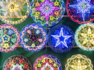 Colorful illuminated Christmas decorations and lanterns displayed in Manila Philippines showing extended Christmas season celebration and festive traditions