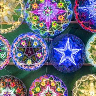 Colorful illuminated Christmas decorations and lanterns displayed in Manila Philippines showing extended Christmas season celebration and festive traditions