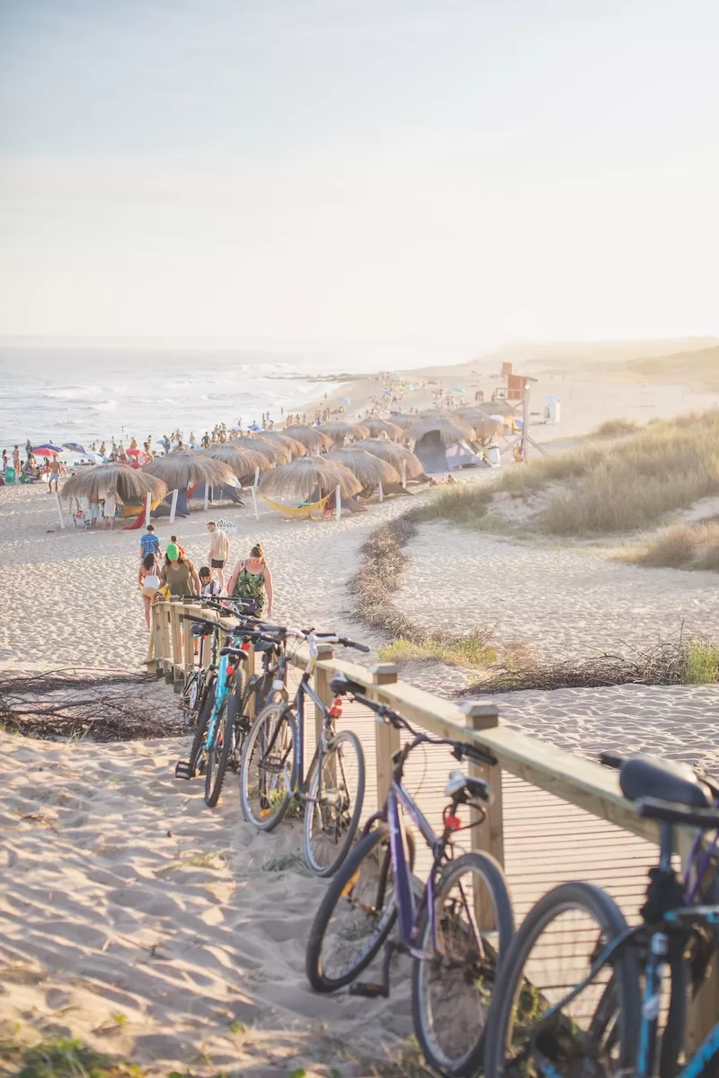Beach scene with bicycles and relaxed atmosphere, representing the lifestyle benefits and personal autonomy that smaller countries offer to expats and globally mobile individuals