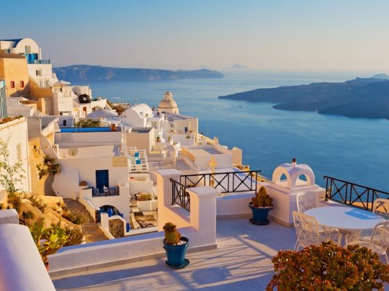 A colorful street in Oaxaca, Mexico, with a mountain in the background, representing an authentic travel experience beyond the resort.