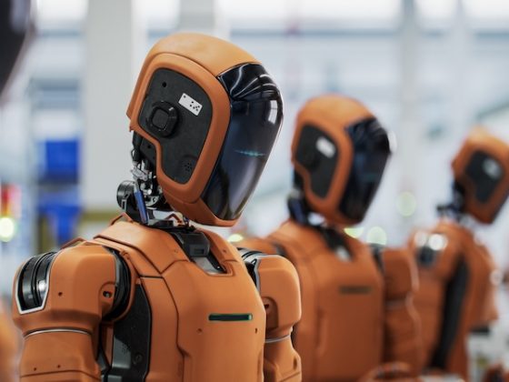Humanoid robots lined up in an industrial facility, representing artificial intelligence technology and automation innovations discussed in global news trends
