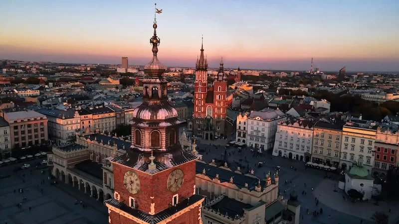 European city skyline at evening showing mixed architecture and urban life representing affordable cities for long-term living and settlement
