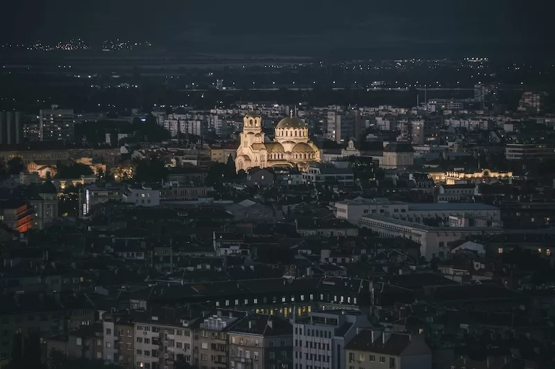 Sofia Bulgaria cityscape at night showing illuminated buildings and Orthodox churches representing most affordable European capital city