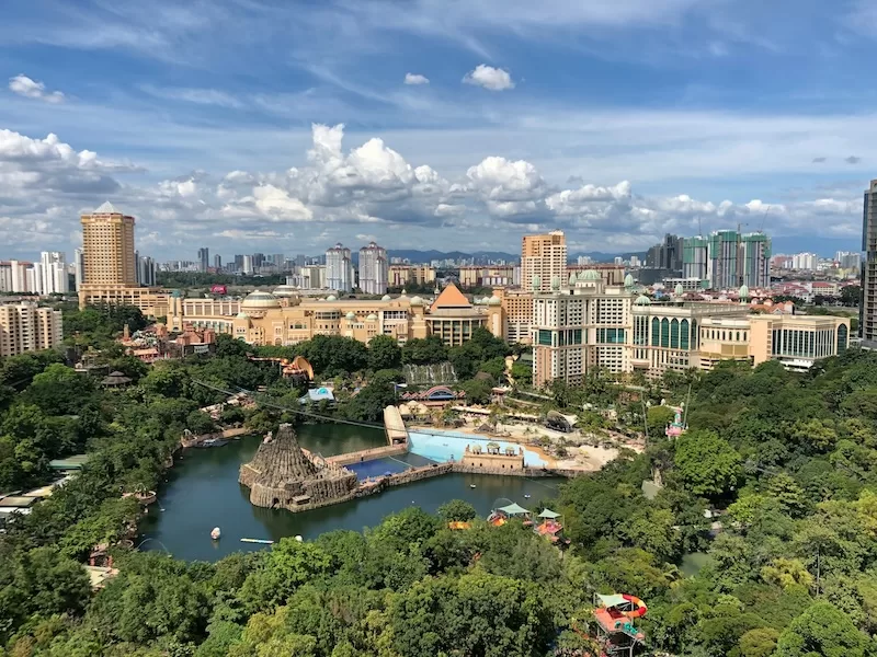 Urban cityscape with modern buildings, green spaces, and river showing developed infrastructure and quality of life appealing to expats seeking affordable cities