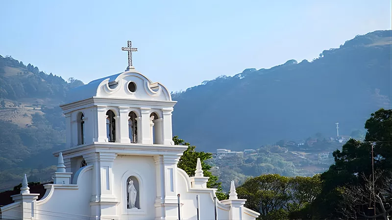 Whitewashed walls and hillside chapels mark the places where neighbors have met for generations. Tradition still has its landmarks, even as modern life moves around them.