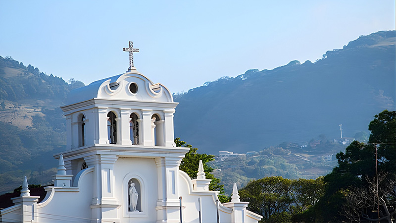 Whitewashed walls and hillside chapels mark the places where neighbors have met for generations. Tradition still has its landmarks, even as modern life moves around them.