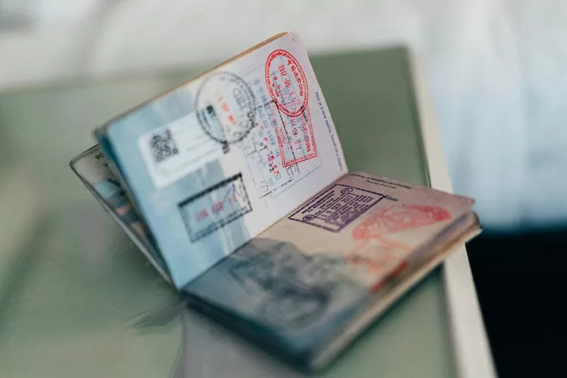 Passport with international visa stamps relevant to permanent residency pathways