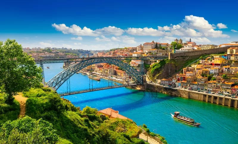 Porto Portugal cityscape with colorful buildings cascading toward Douro River showing why it's becoming Europe's top expat destination for living and remote work