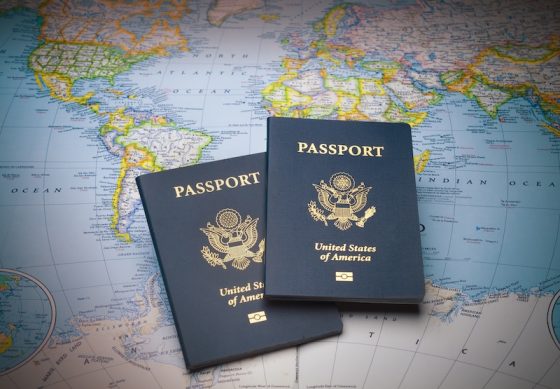 Brown leather travel bag with passport and boarding pass at airport check-in counter showing international travel and global mobility for expats planning relocation