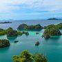 Lush green islands with turquoise water in Raja Ampat, Indonesia, a top destination for sustainable travel on a budget and eco-friendly tourism in Southeast Asia