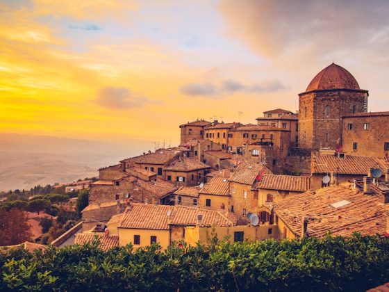 A stunning sunset over the ancient, terracotta-roofed town of Volterra, Italy, a dream location for those considering the country's €1 house experiment.