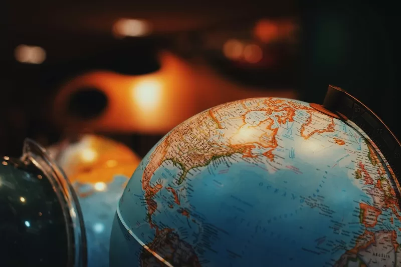 Illuminated globe showing detailed world map with countries highlighted representing global citizenship rankings and international travel opportunities for passport holders