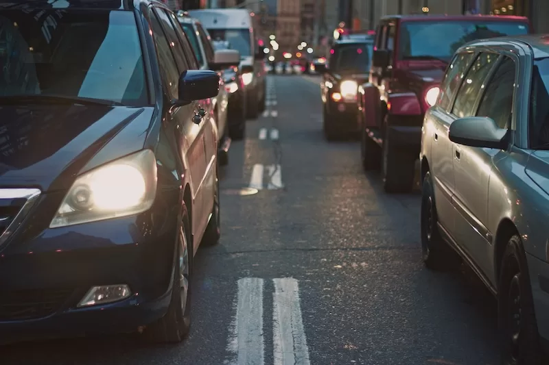 Urban traffic jam at dusk showing congested city street, representing lifestyle pressures and pace of living that motivate families to relocate overseas