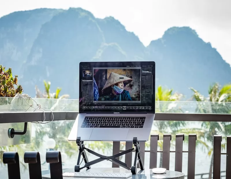 Remote work laptop setup on mountain terrace showing digital nomad lifestyle and location flexibility for remote workers