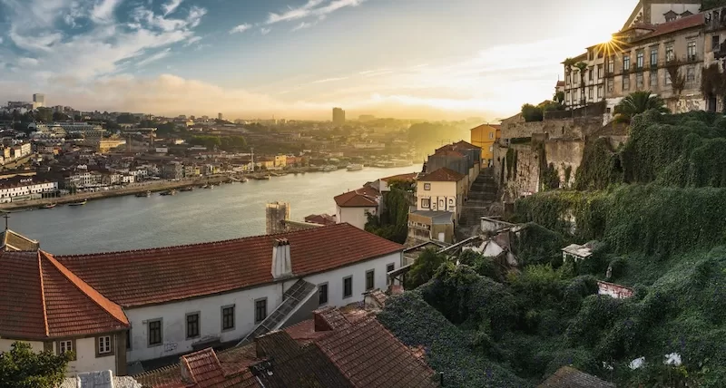 Golden sunset light over Porto and Douro River creating the "Rio Douro" or River of Gold effect that makes the city a beautiful destination for expats