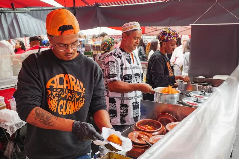 A street food vendor in Brazil preparing acarajé, a traditional Afro-Brazilian dish, offering a taste of authentic local culture.