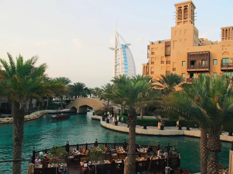 Dubai waterfront with Burj Al Arab and outdoor dining showing UAE luxury lifestyle and residency appeal for globally mobile individuals and high-net-worth expats