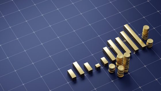 A three dimensional render of ascending gold coin stacks arranged like a rising bar chart on a dark blue digital grid, symbolizing financial growth and wealth.