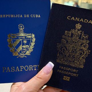 Two passports including a blue Cuban passport and a Canadian passport held together, representing international travel and dual citizenship documentation