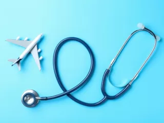 Stethoscope shaped around airplane symbolizing international healthcare access
