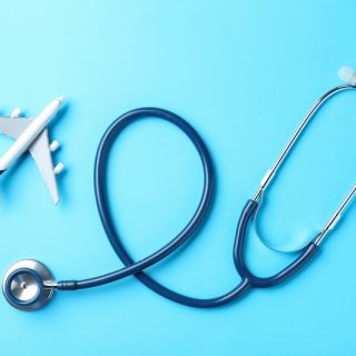 Stethoscope shaped around airplane symbolizing international healthcare access