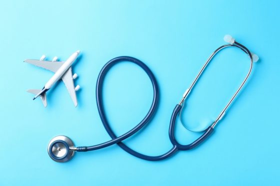 Stethoscope shaped around airplane symbolizing international healthcare access