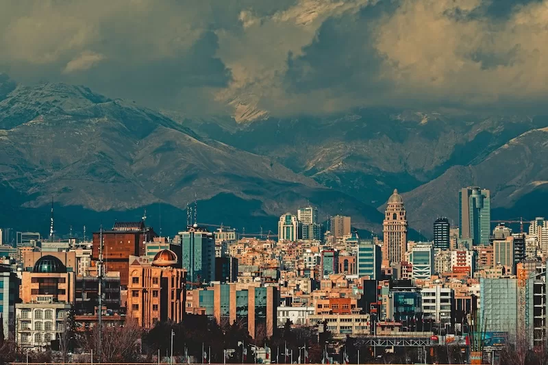 Tehran skyline with mountains during rising geopolitical tensions in the Middle East