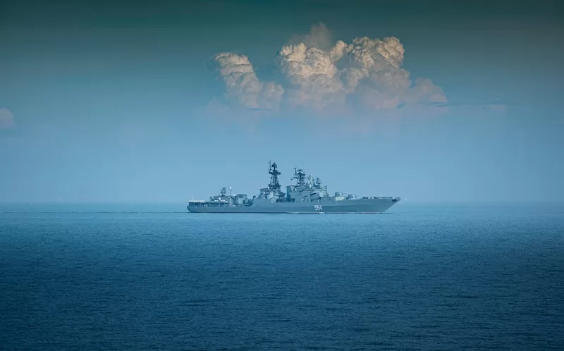 US naval warship at sea under storm clouds signaling rising Middle East tensions