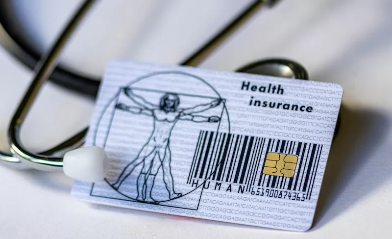 Health insurance card with stethoscope showing importance of coverage abroad