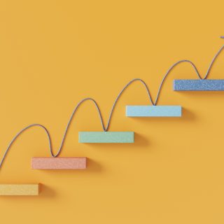 Upward arrow moving across rising steps representing growth and progress.