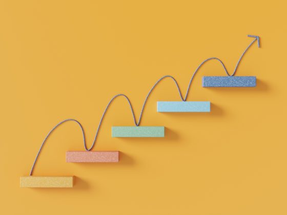 Upward arrow moving across rising steps representing growth and progress.