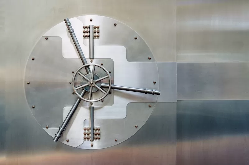Large steel bank vault door symbolizing financial security, asset protection, and institutional stability