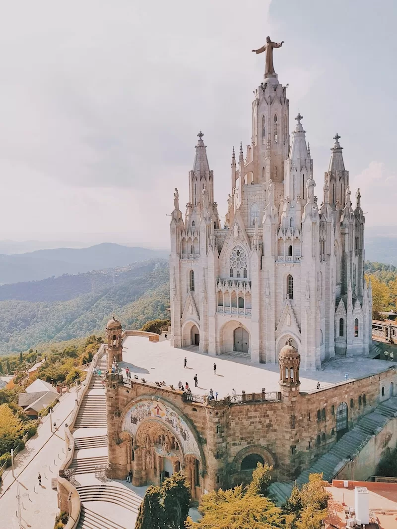 Large hilltop basilica in Spain overlooking a mountainous landscape under soft daylight