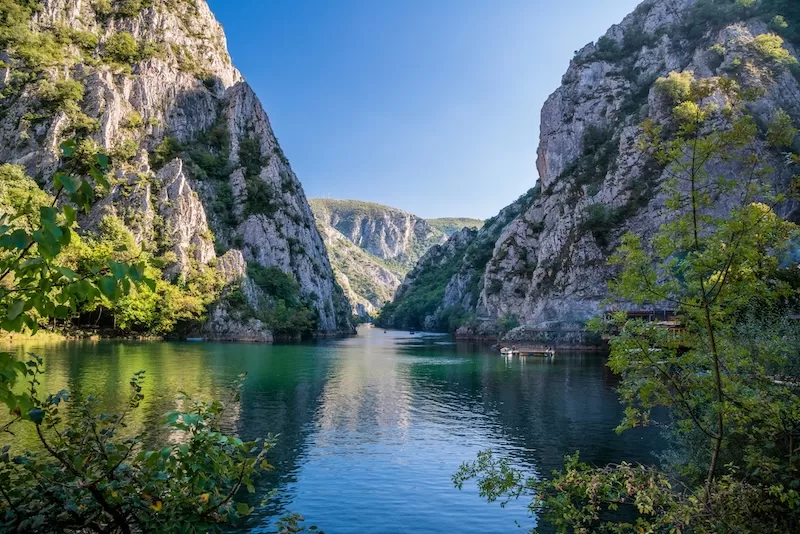 River flowing through a steep rocky canyon in North Macedonia surrounded by cliffs and greenery.