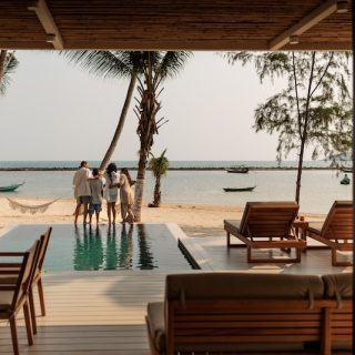 Luxury beachfront villa with a private pool and ocean view, representing residency by investment and lifestyle migration.