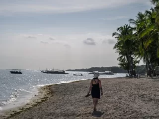Woman walking along a quiet beach in the Philippines