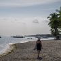 Woman walking along a quiet beach in the Philippines