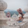 Traveler overlooking a historic Nicaraguan city from a terrace framed by white columns