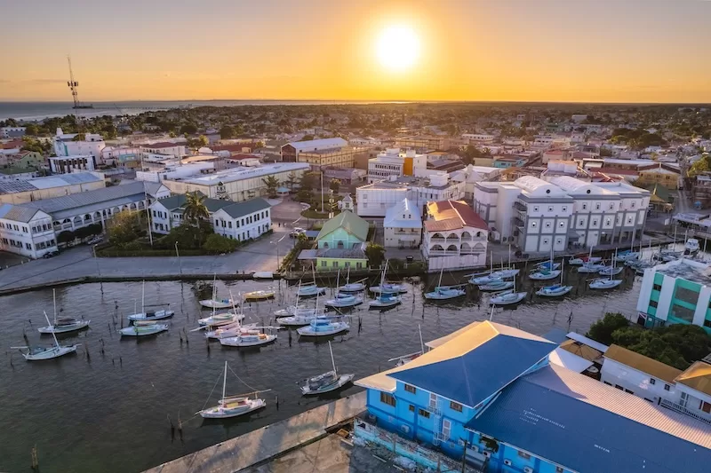 Aerial view of Belize City waterfront and marina at sunset