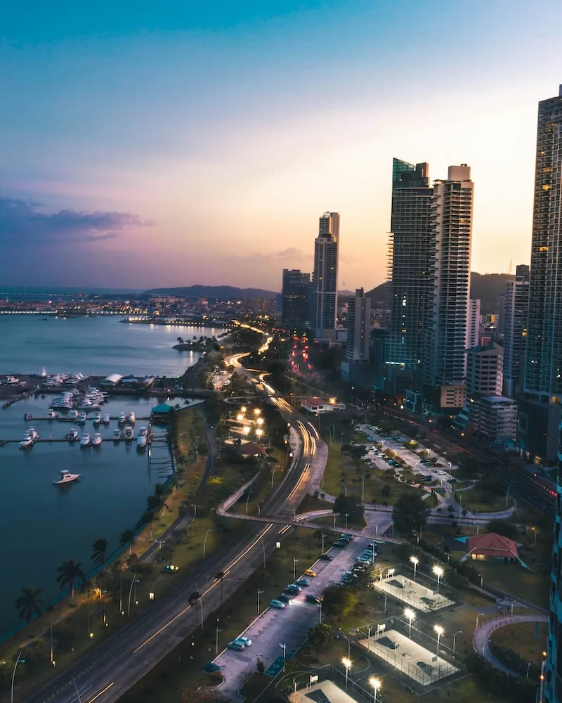 Panama City skyline and waterfront at dusk with modern towers and coastal roadway