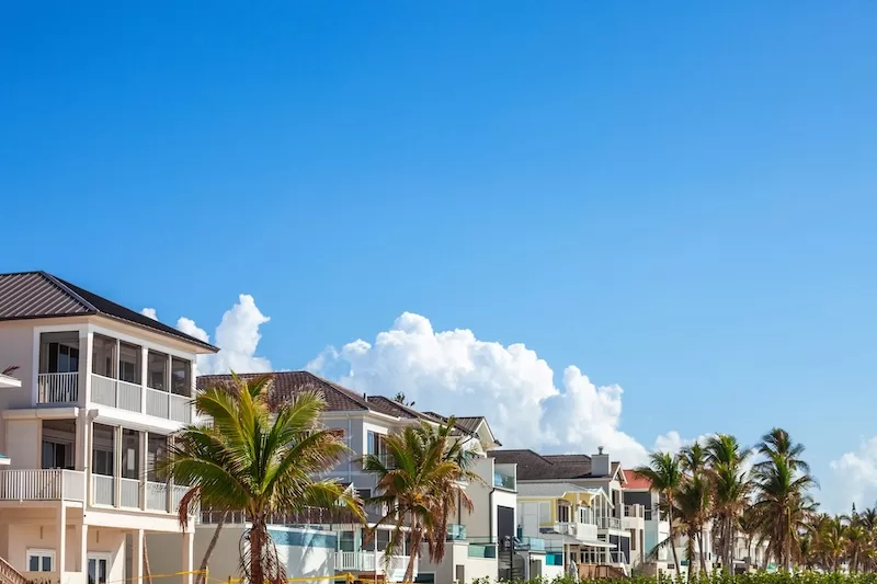 Palm-lined waterfront homes in a sunny Florida coastal neighborhood
