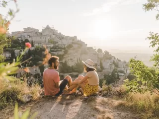 Couple overlooking a European village while slow traveling