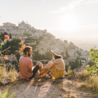 Couple overlooking a European village while slow traveling